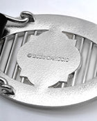 CANCCIO ORNA silver buckle close up with embossed branding engravement, texture backside close up